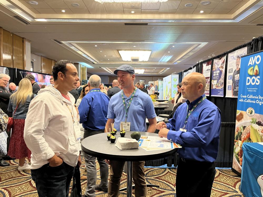 CAC’s Alexei Rudolf and Dave Cruz discuss the California avocado season with a UC-Davis culinary team member.
